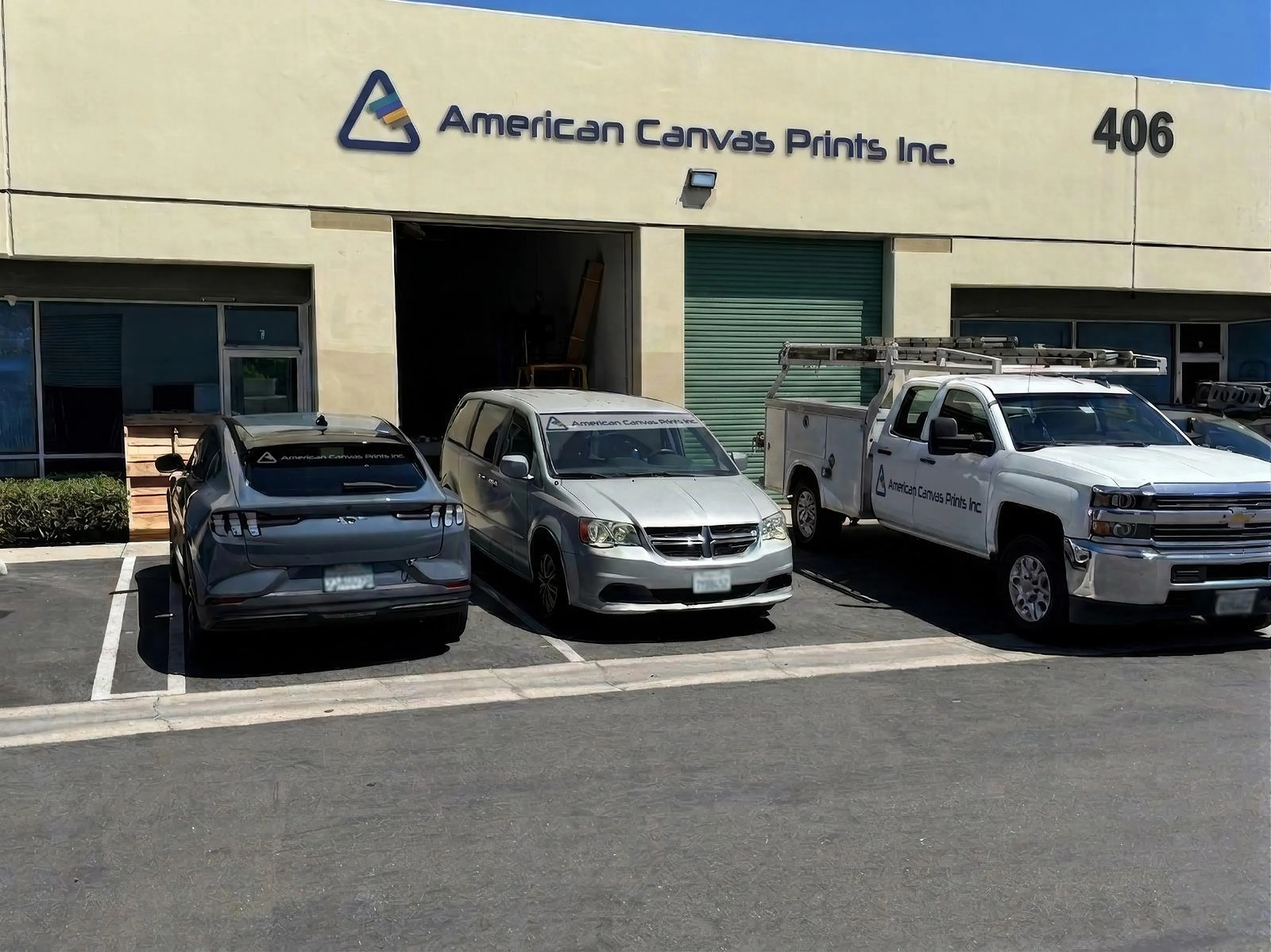 American Canvas Prints building at 406 E Commonwealth Ave in Fullerton, California, with company vehicles out front